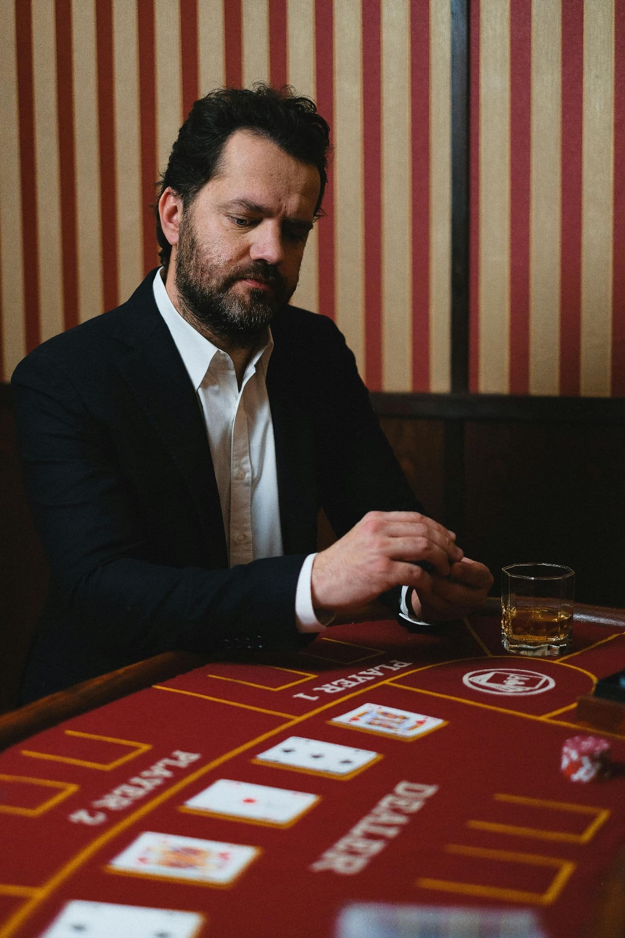 Guest seated at casino table with cards