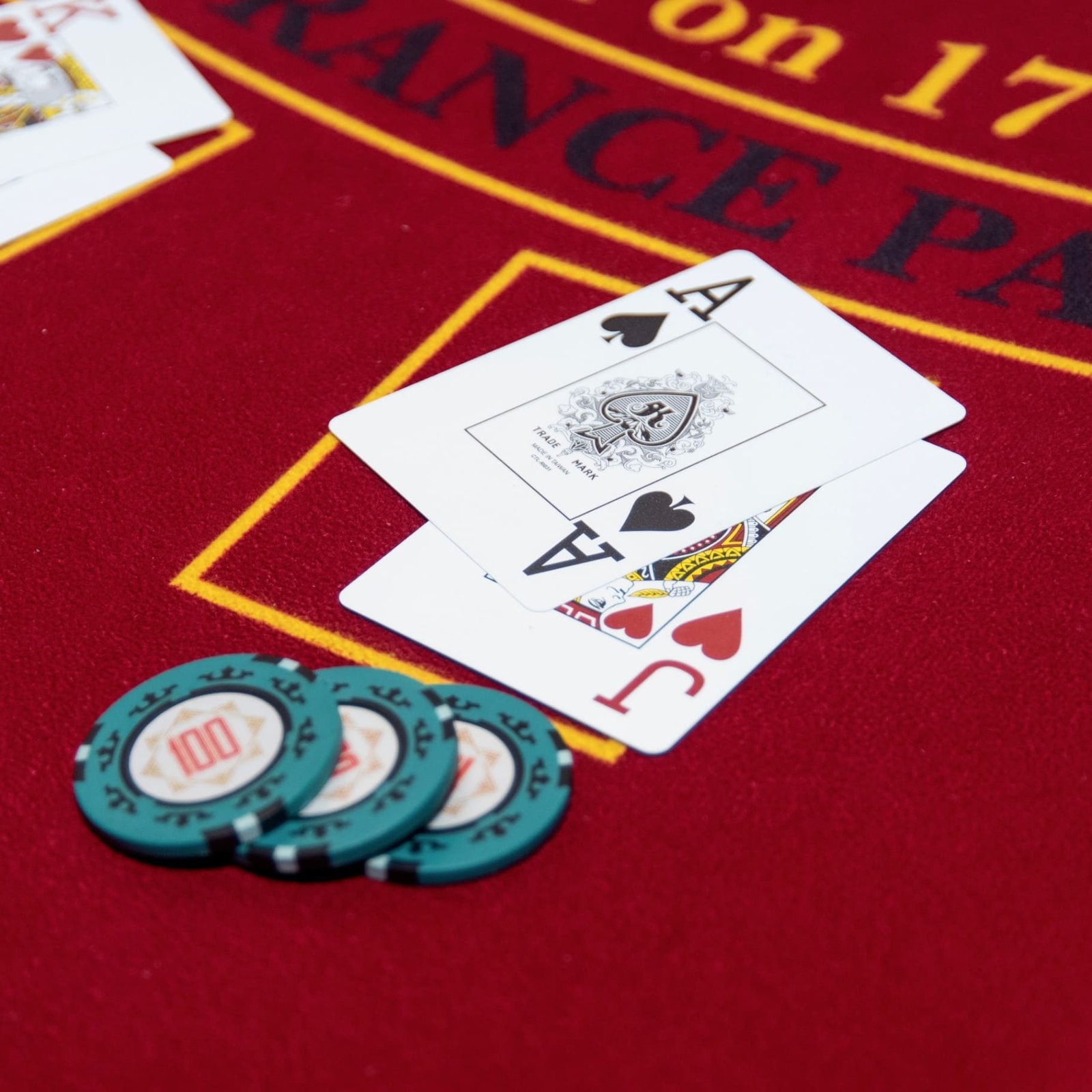 Ace and Jack on blackjack table with teal chips